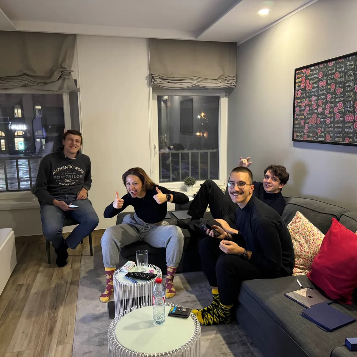 Four of the team working from a living room, laptops out